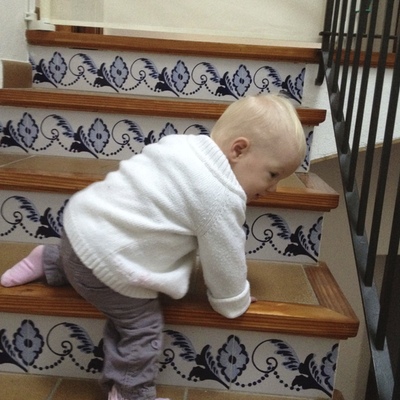 A baby climbing the stairs