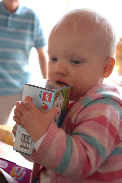 A baby opening a present