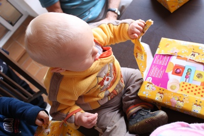 A baby opening presents