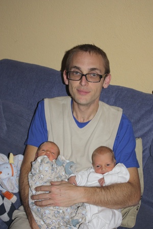 A man with 2 small babies