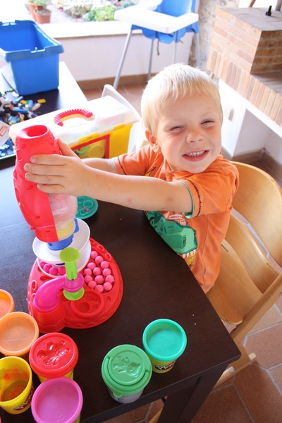 A boy playing with playdoh