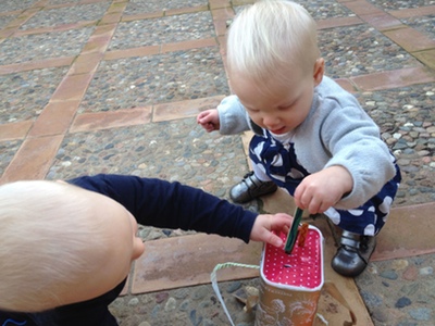 Babies playing with a toy